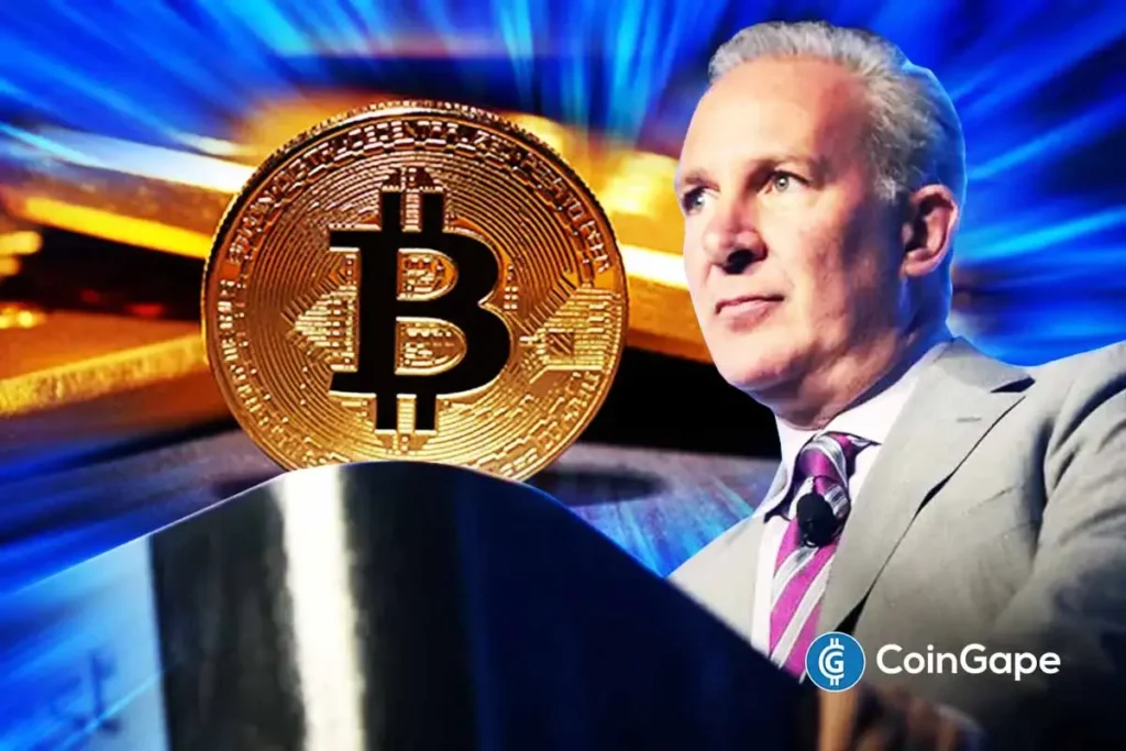 Will BTC Be the Next Global Reserve Currency? Peter Schiff Says No Peter Schiff speaks as Bitcoin and gold appear on screen, highlighting his criticism of crypto as a global reserve asset.